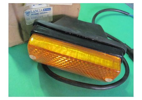 Fanale anteriore Olsa destro (corpo in plastica nera) con cuffia di protezione Autobianchi A112, A112 Abarth 1^, 2^, 3^ serie ('69-'77)