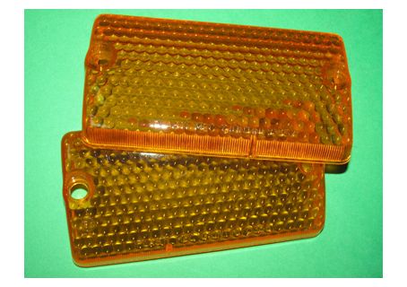 Coppia plastiche arancio fanali anteriori Autobianchi A112 1^-2^-3^ serie ('69-'77) - Foro grande per vite in plastica