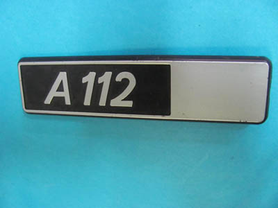 Scritta in plastica posteriore destra Autobianchi A 112 (fondo nero liscio)